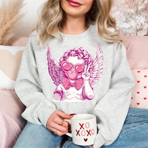 a woman sitting on a couch holding a coffee mug