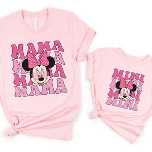 a couple of pink shirts with minnie mouse on them