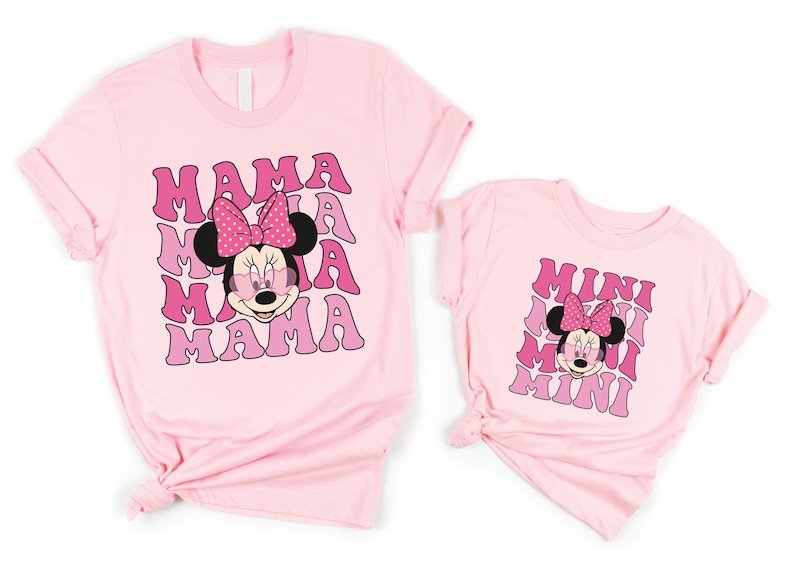 a couple of pink shirts with minnie mouse on them