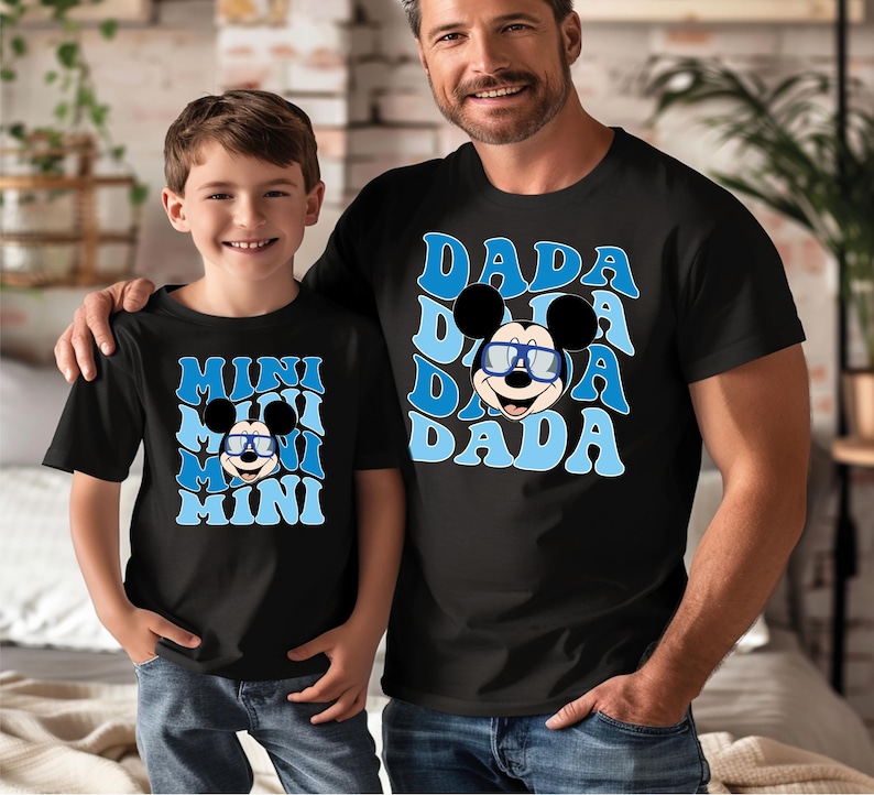a man and a boy wearing mickey mouse shirts
