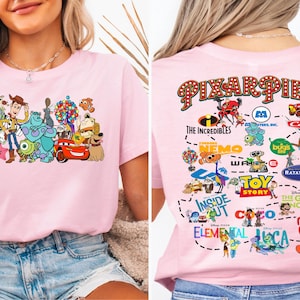 a woman wearing a pink shirt with cartoon characters on it