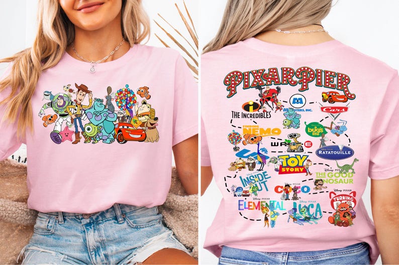 a woman wearing a pink shirt with cartoon characters on it