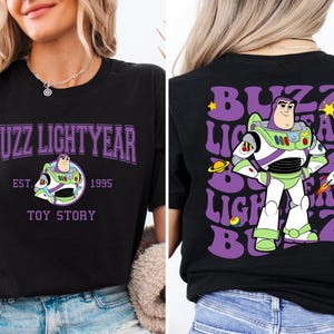 a woman wearing a buzz lightyear toy story t - shirt