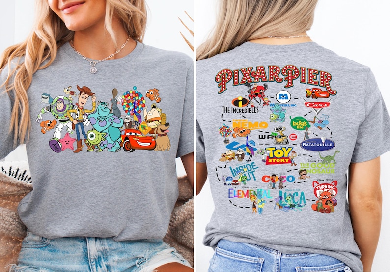 a woman wearing a gray shirt with cartoon characters on it