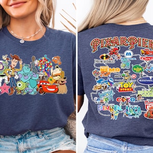 a woman wearing a blue tshirt with cartoon characters on it