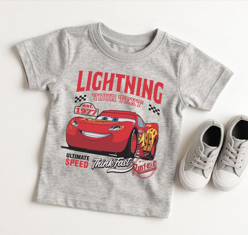 A gray t-shirt with a red and yellow design featuring a cartoon car and the text "Lightning" and "Your Text" printed on it.