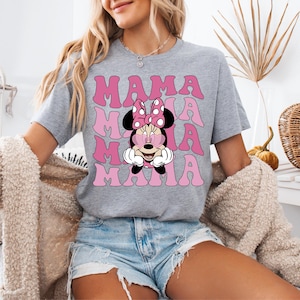 May include: A gray t-shirt with a pink and white graphic of Minnie Mouse with the word "MAMA" repeated in pink letters.