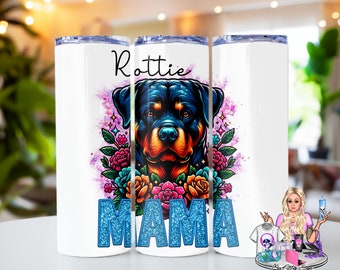 May include: White tumbler with a Rottweiler dog graphic and the text "Rottie Mama" in blue glitter. The dog is surrounded by pink, purple, and blue flowers.