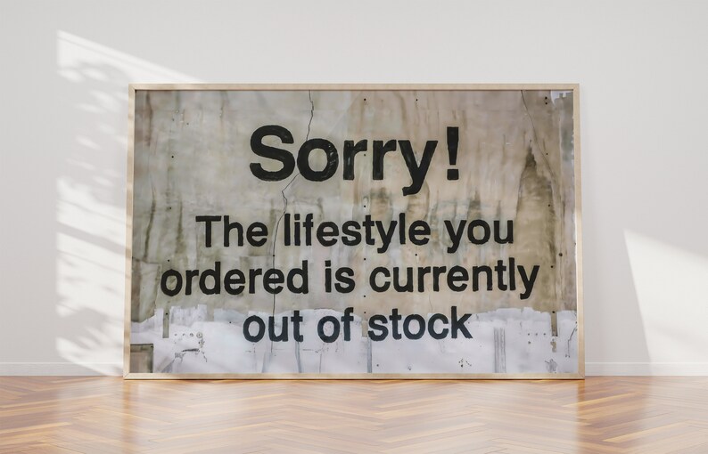 May include: A framed sign with a distressed, textured background. The sign reads "Sorry! The lifestyle you ordered is currently out of stock."