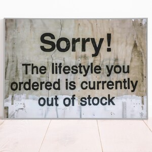 May include: A distressed, white sign with black text that reads "Sorry! The lifestyle you ordered is currently out of stock."