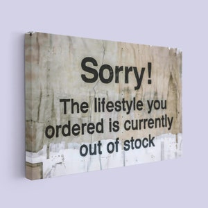 May include: A weathered, white sign with black text that reads "Sorry! The lifestyle you ordered is currently out of stock."