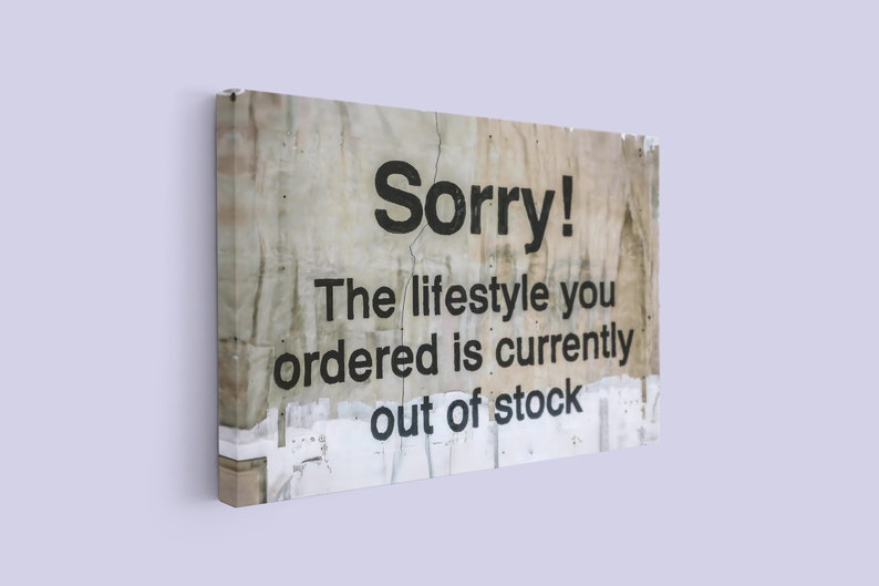 May include: A weathered, white sign with black text that reads "Sorry! The lifestyle you ordered is currently out of stock."
