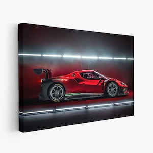 May include: A red Ferrari 296 GT3 race car displayed in a studio setting with horizontal white light strips. The vehicle features a large rear wing, black aerodynamic components, and dark grey wheels, captured from a side profile perspective.