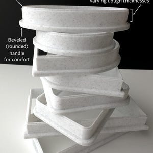 a stack of white plates sitting on top of a table
