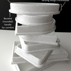 a stack of white plates sitting on top of a table