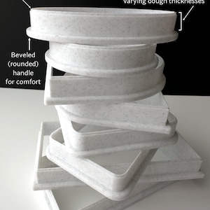 a stack of white plates sitting on top of a table