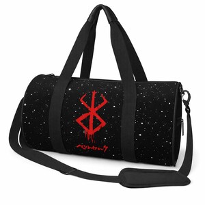May include: Black duffel bag featuring a starry night pattern and a red graphic symbol. The bag includes a shoulder strap and handles. Japanese text is below the red symbol.