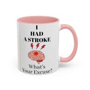 May include: White ceramic mug with a pink interior and handle. The mug features the text "I HAD A STROKE" above a brain graphic with red lightning bolts and the text "What's Your Excuse?"