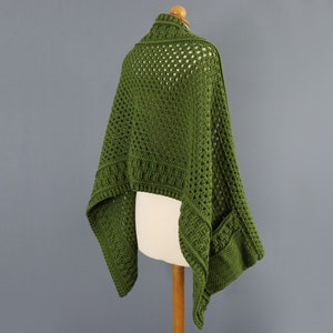 May include: A green crochet shawl with a lacy pattern and a pocket on one side.