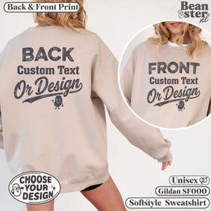 May include: A beige crewneck sweatshirt featuring dark gray text on the back and front. The back displays the words BACK Custom Text Or Design with a small cartoon potato character. The front shows FRONT Custom Text Or Design with a similar potato.