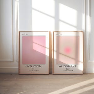 May include: Three framed prints with pink and purple gradients. The prints have the words "Intuition 111 Angel Number", "Alignment 222 Angel Number", and "Abundance 888 Angel Number".