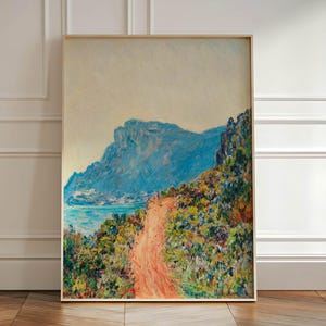 May include: A painting of a winding dirt road leading up a mountainside with a blue body of water in the distance. The sky is a light blue and the mountain is a dark blue. The road is surrounded by green trees and bushes.