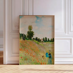 May include: A painting of a field of red poppies with two figures walking in the distance. The sky is blue with white clouds. The painting is framed in a wooden frame.