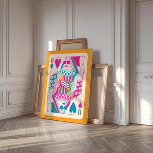 May include: A Queen of Spades playing card with a colorful design. The queen is wearing sunglasses and holding a glass of champagne. The card is on a yellow background.