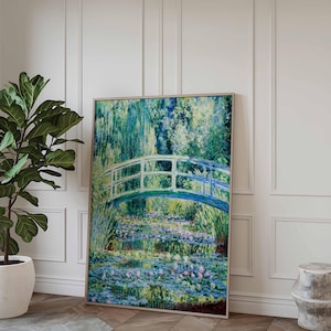 May include: A framed painting of a white bridge over a pond with water lilies. The bridge is painted in a light blue color and the water lilies are painted in shades of purple, blue, and green. The background is a lush green forest.