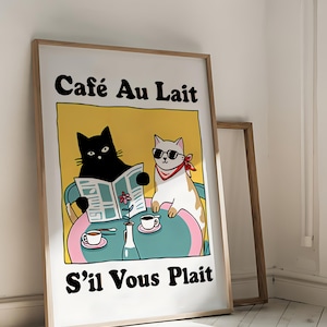May include: A framed illustration of two cats sitting at a table with coffee cups and a newspaper. The text on the poster reads "Cafe Au Lait S'il Vous Plait".