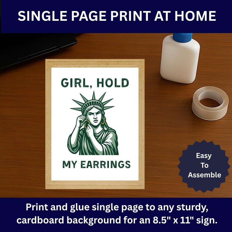 May include: A framed print with the text "GIRL, HOLD MY EARRINGS" and an illustration of the Statue of Liberty. The print is on a wooden surface with a glue bottle and tape. The sign is designed to be printed at home and is 21.6cm x 27.9cm.