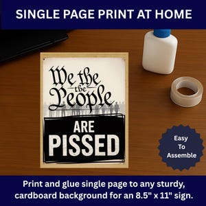 May include: A framed print with the words "We the People ARE PISSED" in black and white. The print is designed to be printed at home and glued to a 21.6 cm x 27.9 cm cardboard background. A bottle of glue and tape are next to the print.