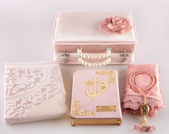 May include: A pink velvet prayer set with a matching prayer rug, a book with gold lettering, and a set of prayer beads. The set comes in a pink velvet box with a pearl necklace and a rose.
