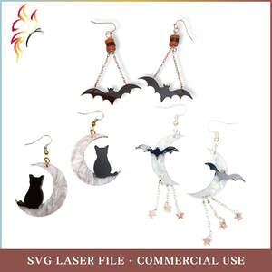 May include: A selection of Halloween earrings featuring bat and cat silhouettes, and crescent moon designs. Some earrings have dangling chains with star-shaped charms. The earrings are in black, white, and silver.