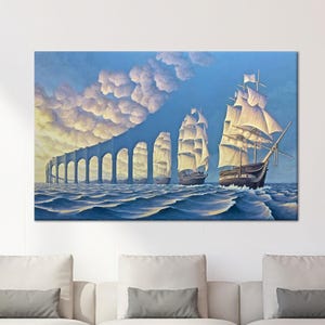 May include: A canvas print showing three sailing ships on a wavy sea, with a series of arches in the background. The sky is a gradient of blue and white, with fluffy clouds. The ships have white sails and dark hulls.