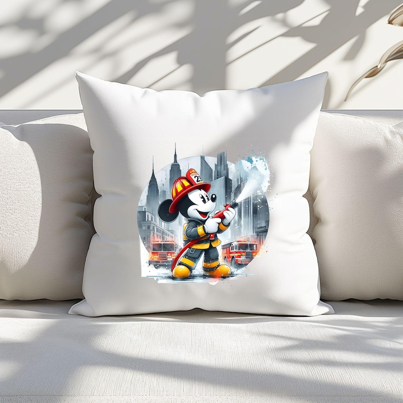 May include: White throw pillow with a colorful illustration of Mickey Mouse dressed as a firefighter in front of a city skyline. Mickey is holding a hose and spraying water.