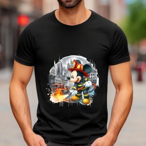 May include: Black t-shirt with a graphic of Mickey Mouse dressed as a firefighter in front of a city skyline. The graphic includes a fire hose and flames.