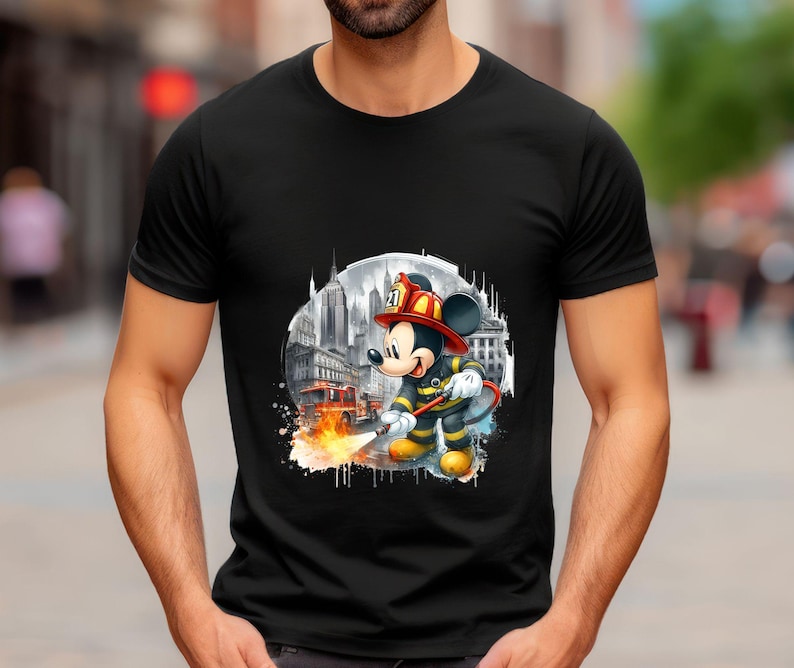 May include: Black t-shirt with a graphic of Mickey Mouse dressed as a firefighter in front of a city skyline. The graphic includes a fire hose and flames.