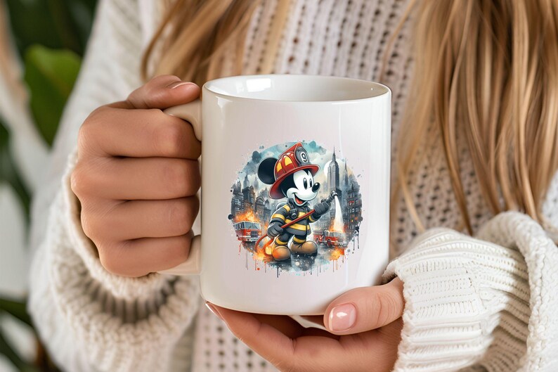 May include: White ceramic mug with a colorful illustration of Mickey Mouse dressed as a firefighter holding a hose. The illustration is surrounded by a watercolor-style background with buildings and flames.