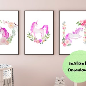 May include: Three printable wall art prints featuring watercolor illustrations of unicorns with floral wreaths. The unicorns are pink and white with pink manes and tails. The floral wreaths are pink, white, and green.