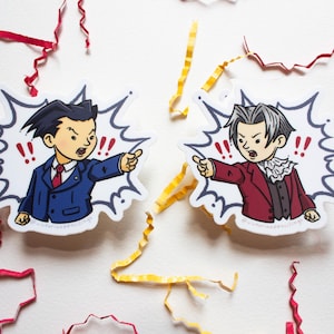 May include: Two cartoon stickers featuring characters in a heated argument. One sticker shows a character in a blue suit, the other in a red suit. Both are pointing with exclamation marks in speech bubbles.