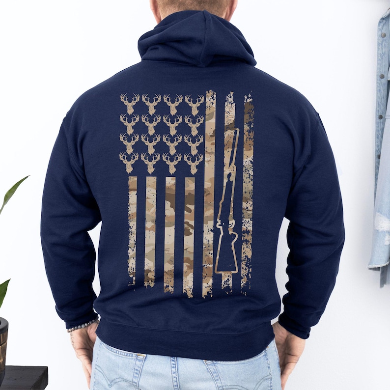 Cozy camo hoodie featuring a bold deer silhouette merged into USA flag, great for outdoor wear during fall and winter.