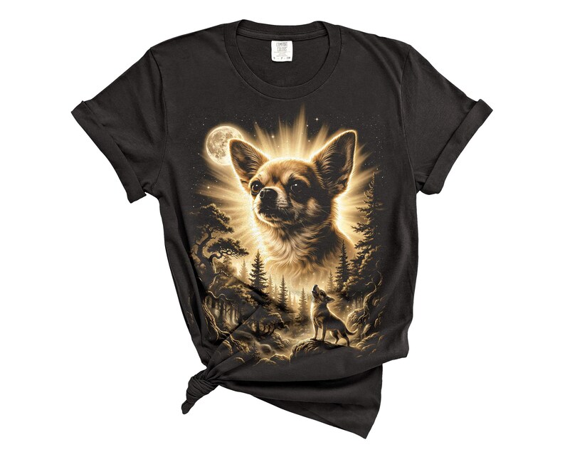 May include: Black t-shirt featuring a detailed illustration of a Chihuahua dog with a radiant halo, set against a moonlit forest scene. The design includes a smaller dog silhouette howling at the moon, creating a striking contrast.