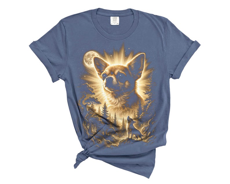 May include: Blue t-shirt featuring a detailed illustration of a Chihuahua dog with a radiant glow, set against a forest and moonlit sky. The design includes a smaller silhouette of a dog howling. The shirt is made of soft material.