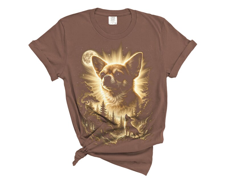 May include: Brown t-shirt featuring a detailed illustration of a Chihuahua dog with a radiant glow, a full moon, and a forest scene. The design includes a smaller dog silhouette. The shirt is knotted at the bottom.