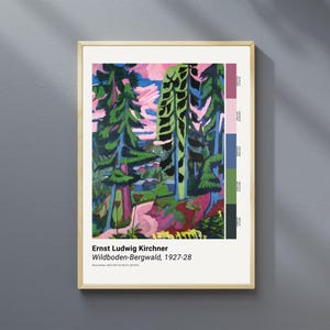 May include: A framed print of Ernst Ludwig Kirchner's "Wildboden-Bergwald, 1927-28" artwork. The painting features a vibrant forest scene with tall green trees, pink and blue skies, and a palette of colors. The frame is a light wood color.