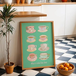 May include: A framed print featuring eight teacups and saucers in various pastel colors, set against a teal background. The phrase "Five o'clock tea time" is written in a script font. The print is displayed near a potted plant and a basket of oranges.