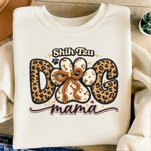 May include: A set of three ceramic mugs with a speckled, matte finish. The mugs are in shades of cream, light gray, and dark gray. Each mug has a simple, minimalist design and a rounded handle.