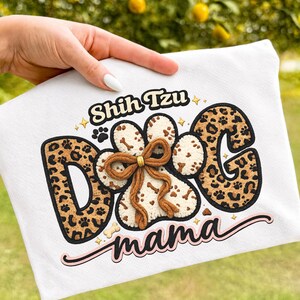 May include: White Shih Tzu Dog Mama cushion cover with a paw print design. The letters "DOG" are in a leopard print pattern. The paw print has a brown bow. The words "Shih Tzu" and "mama" are also on the cushion cover.