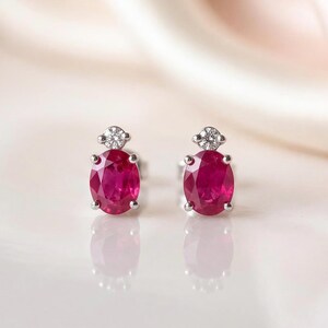 Genuine Ruby and Moving Diamond Oval Stud Earrings in 18k White Gold